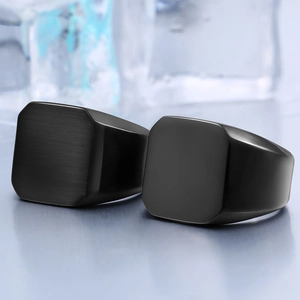 Polished and brushed black stainless steel signet rings for men on an ice background