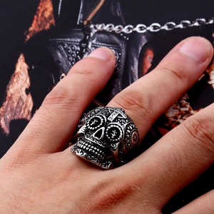 Macro view of vintage silver sugar skull ring with intricate floral gothic carvings