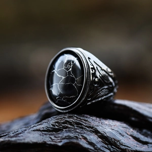 Detailed macro view of vintage stainless steel men's ring with black turquoise stone