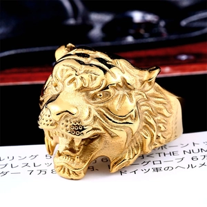 Macro shot of gold stainless steel tiger head ring with detailed 3D relief carving