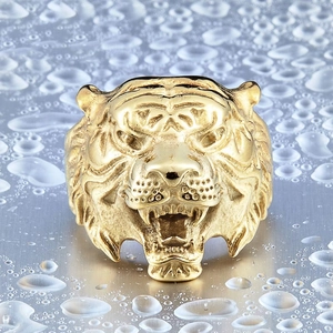 Macro shot of gold-plated tiger head ring with detailed engraving and roaring expression
