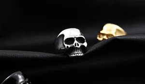 Macro shot of silver gothic skull ring with detailed metal carving and polished finish