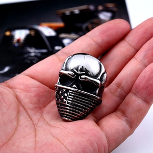 Close-up of vintage punk skull ring with star pattern on a hand-held display