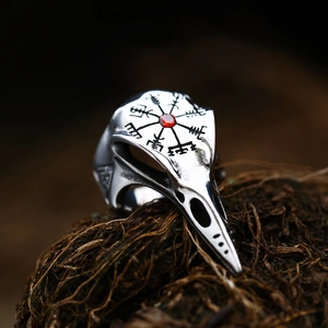 Macro shot of Viking raven skull ring with red gemstone inlay and Vegvisir compass engraving
