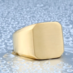 Macro shot of gold signet ring with matte brushed finish on blue water drop background