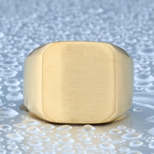 Minimalist brushed gold stainless steel signet ring for men on blue water drop background