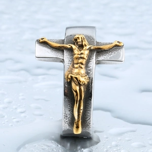 Vintage stainless steel crucifix ring with gold Jesus figure on a polished silver band