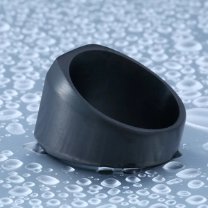 Black matte stainless steel ring with faceted geometric design on water drop background