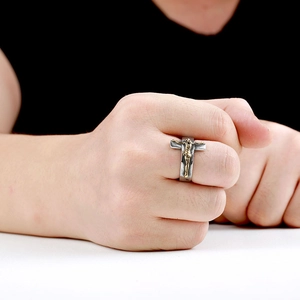 Close-up of vintage bicolored cross ring with gold Jesus figure on silver band