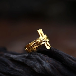 Macro shot of vintage gold-plated crucifix relief and cross engraving on the ring
