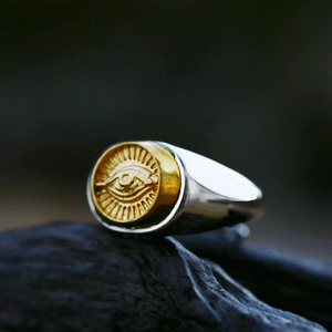 Vintage two-tone stainless steel signet ring with golden Eye of Providence relief on rock