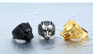 Three men's stainless steel wolf head rings in black, silver, and gold finishes