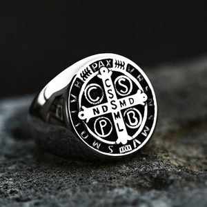 Macro shot of Saint Benedict Medal signet ring with vintage cross and religious symbols