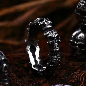 Macro detail of retro skull rings with oxidized silver finish and gothic punk aesthetic