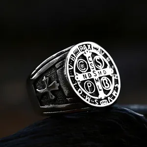 Macro shot of vintage St. Benedict medal ring with religious cross patterns on aged steel