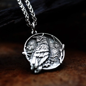 Macro shot of vintage owl pendant with intricate relief details on dark wood background