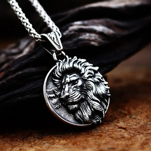 Macro shot of vintage lion head pendant in stainless steel with relief engraving