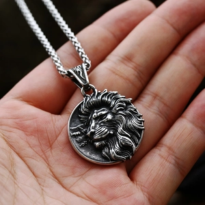 Detail of high relief lion head pendant necklace with vintage silver finish on metal