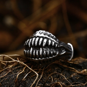 Macro detail of gothic monster ring showing sharp metal teeth and oxidized dark texture