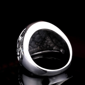 Macro shot of heavy vintage skull ring with intricate embossed texture and dark finish