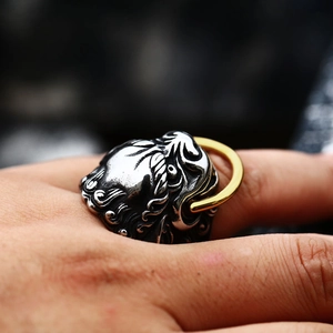 Macro detail of men's vintage lion head ring with gold accents and aged silver finish