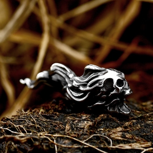 Gothic punk skull pendant in vintage stainless steel on textured natural soil background
