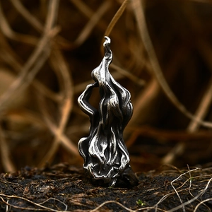 Gothic punk skull pendant in vintage stainless steel on a rustic soil background