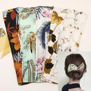 Detail view showing five heatless hair curlers in assorted floral and tropical patterns
