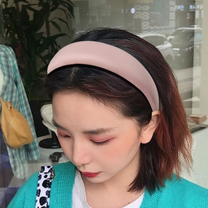 Detail of pink sponge headband on model showing thick padding for volumizing hair