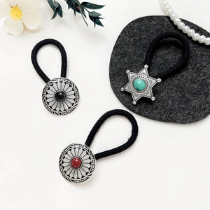 Macro shot of vintage alloy hair ties with turquoise and agate stone inlay detail