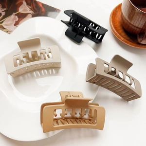 Set of 4 large matte rectangle hair claw clips in Morandi colors displayed on white plate