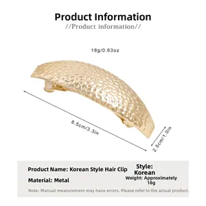 Detail showing high-quality gold metal hair claw clip with unique hammered texture and size marks