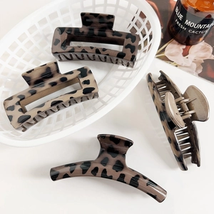 Détail des pinces à cheveux à motif léopard en formes rectangulaires et courbes élégantes