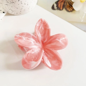Detail of pink marble frangipani hair claw clip made of premium acetate material