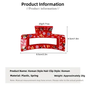 Détail de la pince à cheveux rouge de Noël avec dimensions 8,5cm et motifs festifs