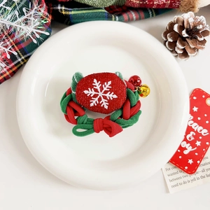 Vue détaillée du chouchou de Noël avec motif flocon et petites clochettes festives dorées