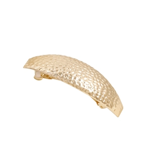 Minimalist golden metal hair clip with a hammered finish and arc geometric design
