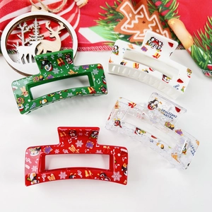 Détail de 4 pinces à cheveux de Noël avec motifs festifs de pingouins et flocons
