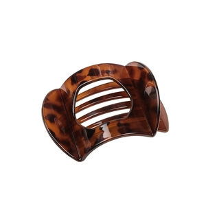 Large dark brown tortoiseshell hair claw clip with curved design and metal spring