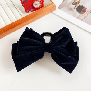 Close-up of black velvet double bow hair claw clip showing soft texture and sturdy grip