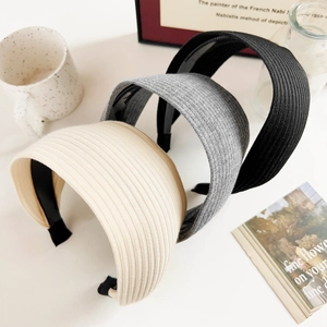 Three-piece set of textured ribbed knit headbands in cream, grey, and black colors