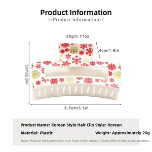 Detailed view of white Christmas hair claw with red and gold snowflake patterns, 8.5cm wide