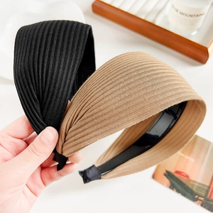 Detail showing black and khaki ribbed knit wide headbands with soft fabric wrapped ends