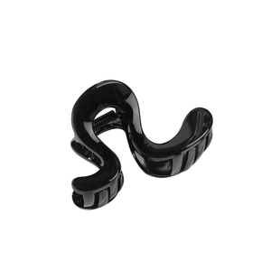 Minimalist black wavy geometric hair claw clip with glossy finish and metal spring