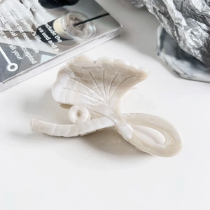 Detail of ginkgo leaf hair claw in cream marble acetate with glossy resin finish
