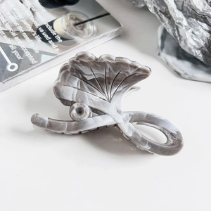 Detailed view of Ginkgo leaf hair claw clip with grey marble pattern texture