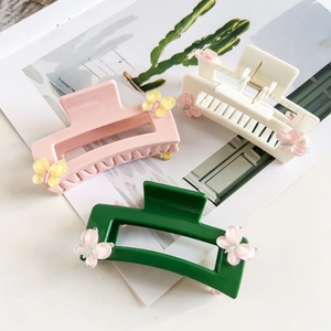 Three-piece set of square butterfly hair claws in pink, white, and dark green resins