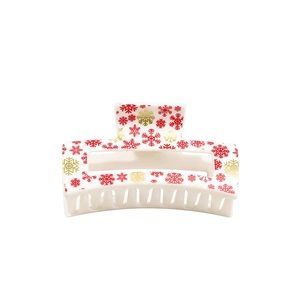 Christmas hair claw clip with red and gold snowflake patterns on a cream rectangle base