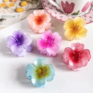 Detailed view of six colorful frangipani flower hair clips in various vibrant pastel shades