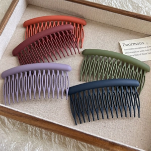 Detailed close-up of 5-piece matte finish circular hair combs in various earthy tones